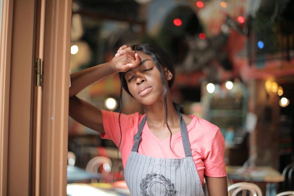 A Black woman who is tired at work and trying not to give up.
