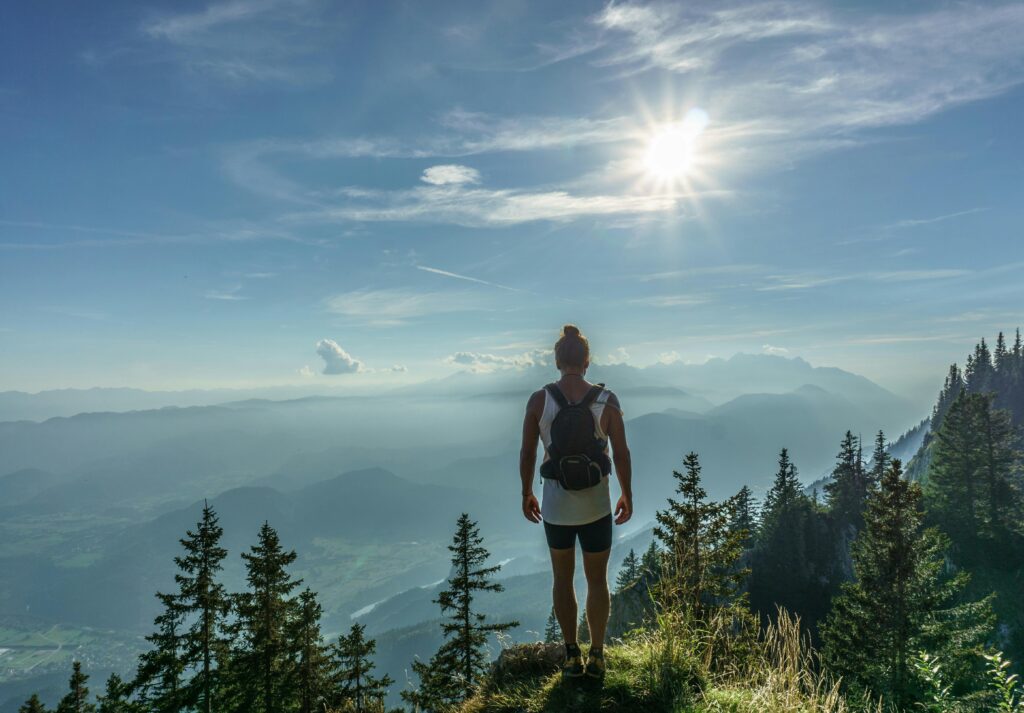 A young woman about to begin a nature journey, one step at a time.